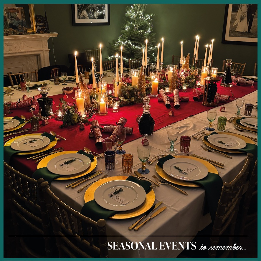 Elegant festive dinner table with candles, Christmas tree and seasonal decorations